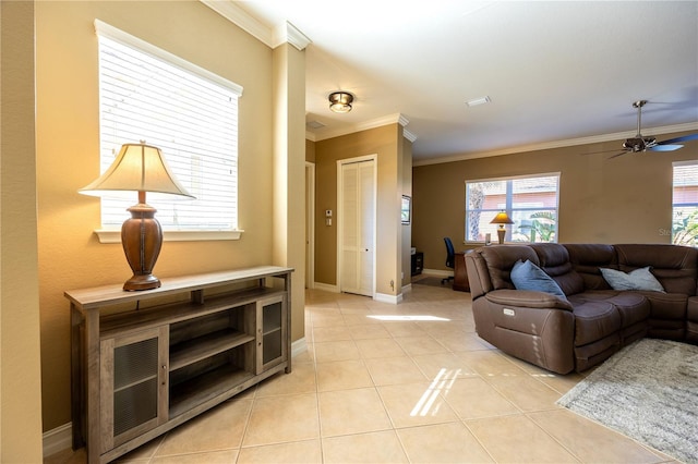 living room featuring ceiling fan, light tile patterned floors, and ornamental molding