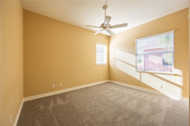 carpeted spare room with ceiling fan