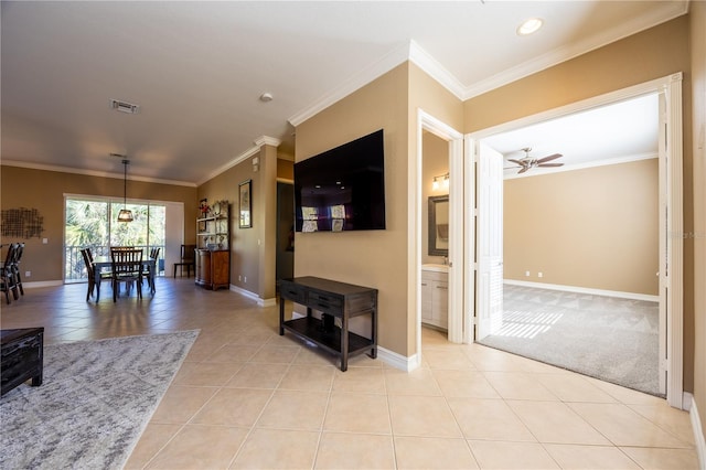 living room featuring light tile patterned floors, ceiling fan, and ornamental molding