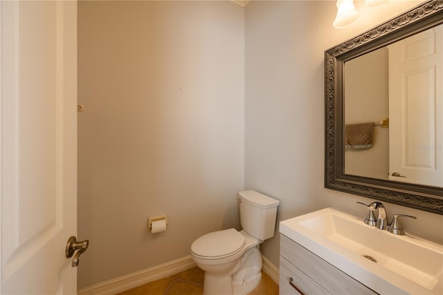 bathroom featuring tile patterned flooring, vanity, and toilet