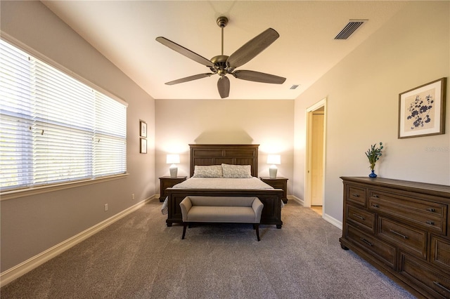 carpeted bedroom featuring multiple windows and ceiling fan