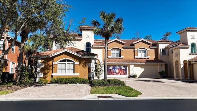 mediterranean / spanish home featuring a garage