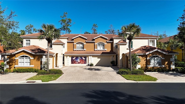 mediterranean / spanish house featuring a garage