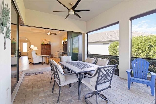 sunroom / solarium featuring ceiling fan