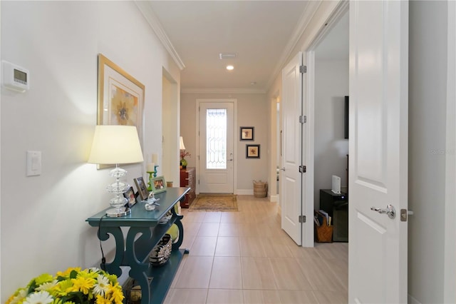 entryway featuring light tile patterned floors and crown molding