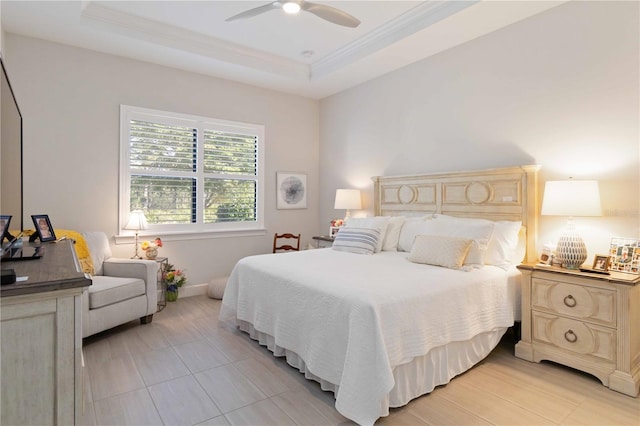 bedroom with ceiling fan and a raised ceiling