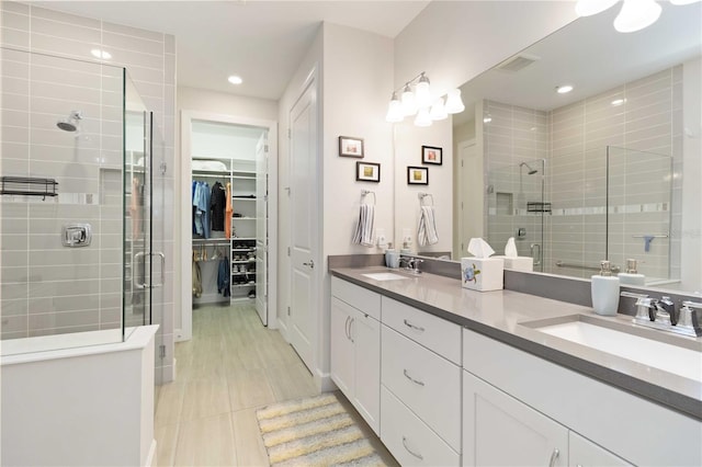 bathroom with tile patterned floors, vanity, and an enclosed shower