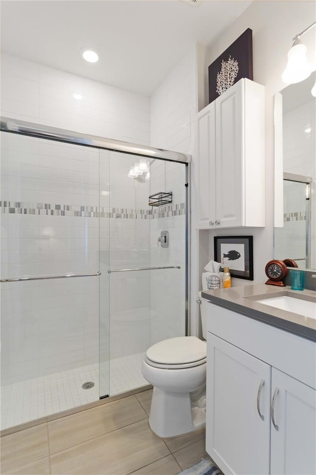 bathroom with walk in shower, vanity, and toilet