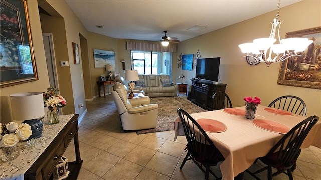 dining space featuring ceiling fan with notable chandelier and light tile patterned flooring