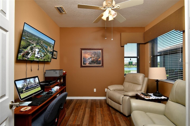 office with a textured ceiling, ceiling fan, and dark hardwood / wood-style floors