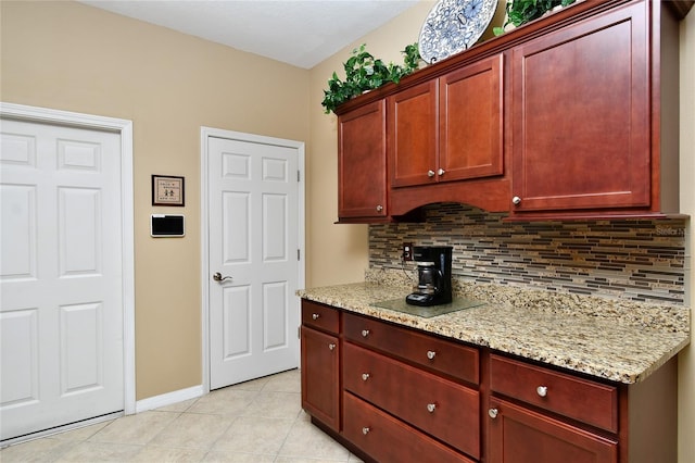 kitchen with light tile patterned floors, tasteful backsplash, and light stone counters