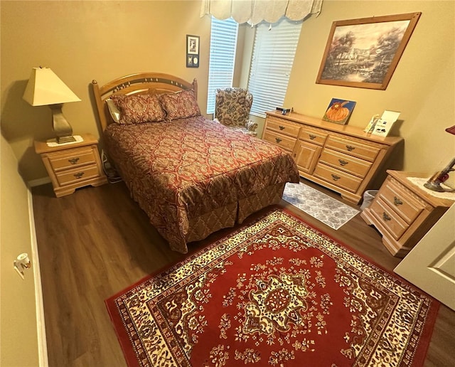 bedroom with dark hardwood / wood-style flooring