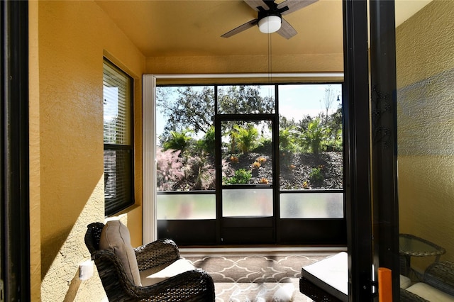 sunroom featuring ceiling fan