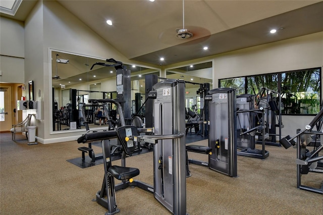 gym featuring light carpet, high vaulted ceiling, and ceiling fan