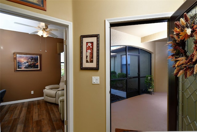 corridor with dark hardwood / wood-style flooring