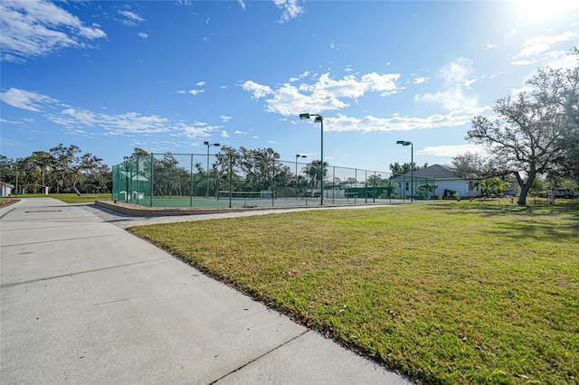 view of home's community with tennis court