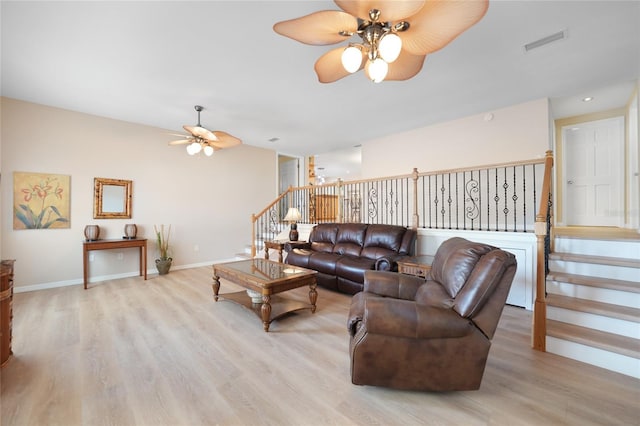 living room with ceiling fan and light hardwood / wood-style flooring