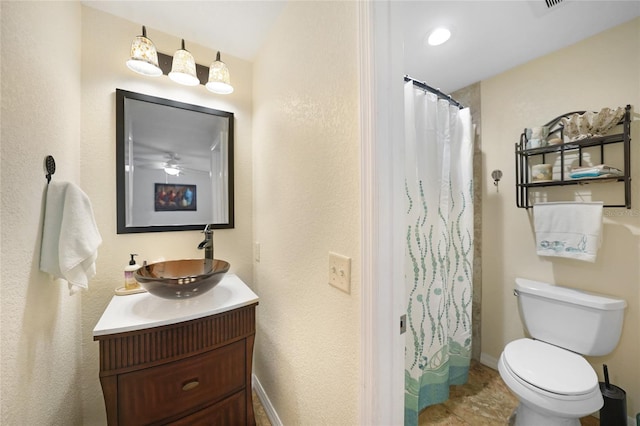 bathroom featuring vanity, toilet, and walk in shower