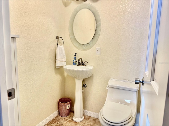 bathroom featuring tile patterned floors and toilet