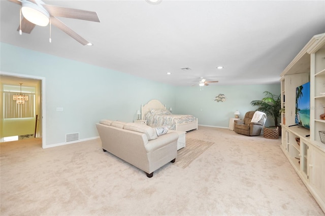 carpeted bedroom with ceiling fan with notable chandelier