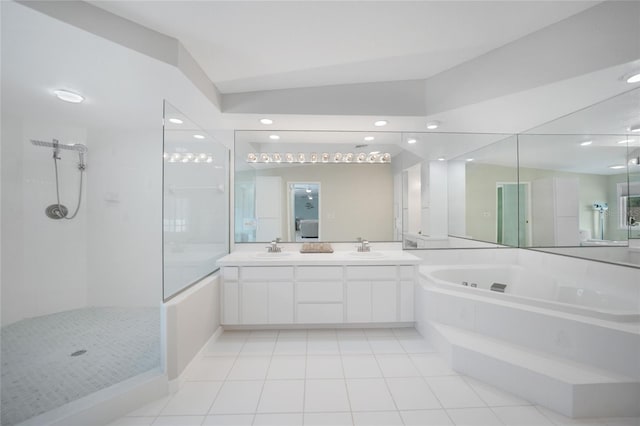 bathroom with tile patterned flooring, vanity, vaulted ceiling, and independent shower and bath