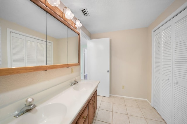 bathroom featuring tile patterned flooring and vanity