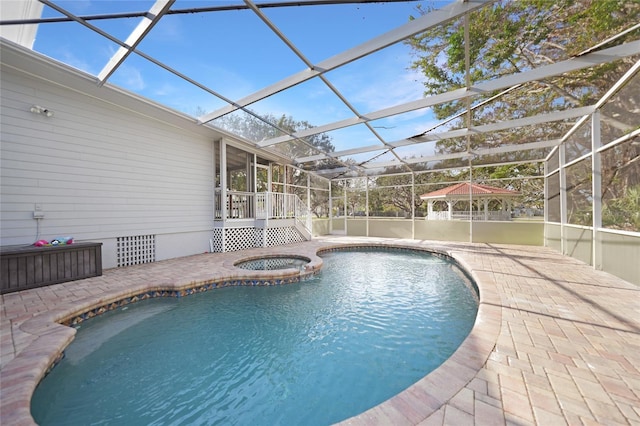 view of pool featuring an in ground hot tub, a patio area, and a lanai