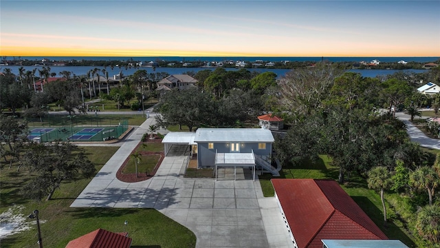 aerial view at dusk with a water view