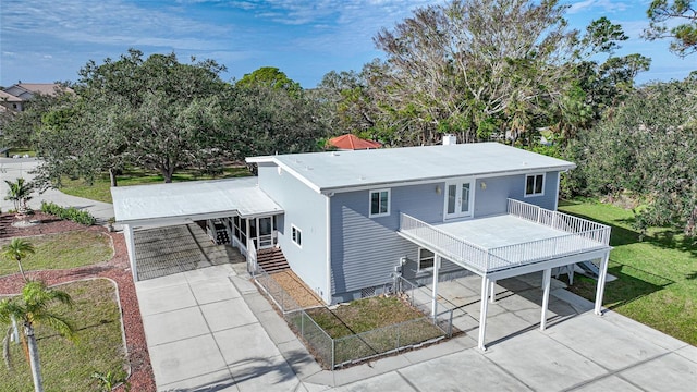 view of front of home featuring french doors, a carport, and a front lawn