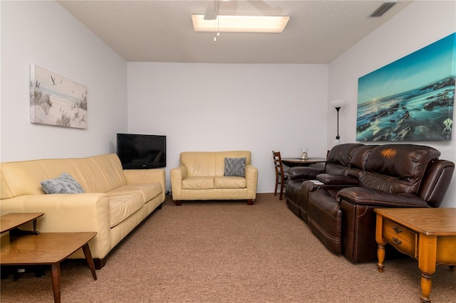 carpeted living room with a textured ceiling