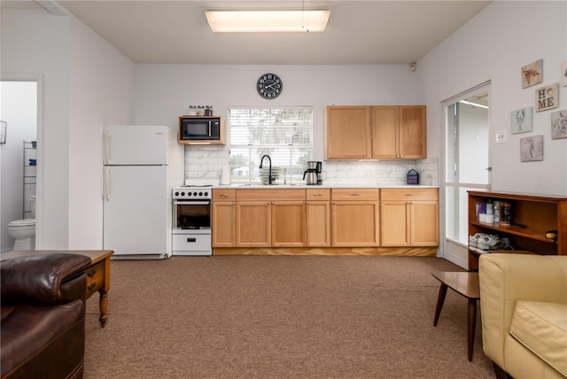 kitchen featuring light brown cabinetry, tasteful backsplash, white appliances, sink, and carpet floors