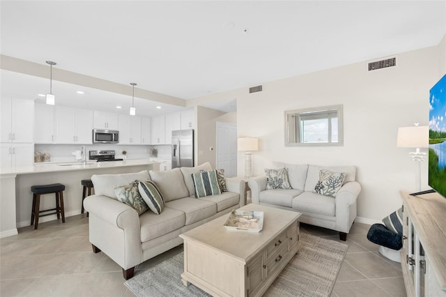 living room with sink and light tile patterned floors