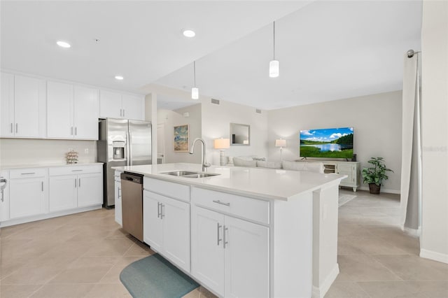 kitchen with pendant lighting, white cabinets, sink, and stainless steel appliances