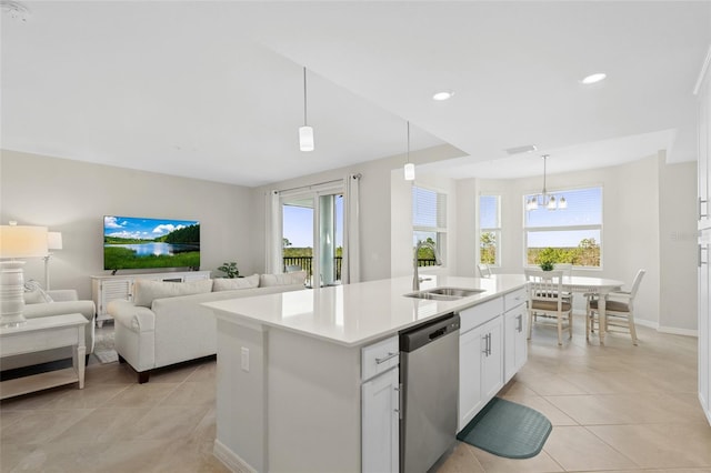 kitchen featuring a kitchen island with sink, sink, pendant lighting, dishwasher, and white cabinetry