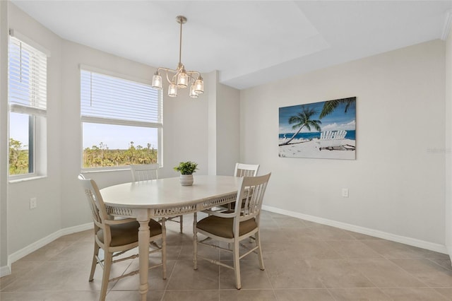 dining space featuring light tile patterned floors, a wealth of natural light, and an inviting chandelier