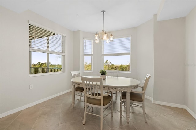 tiled dining area with a chandelier