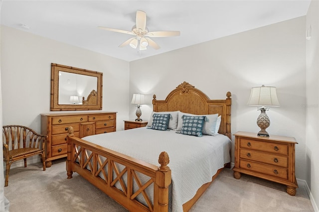 bedroom with ceiling fan and light carpet