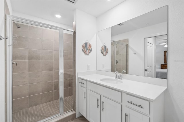 bathroom featuring vanity and a shower with shower door