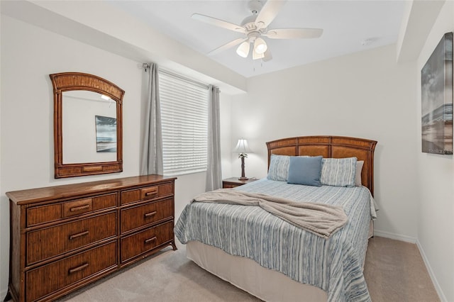 bedroom featuring ceiling fan and light carpet