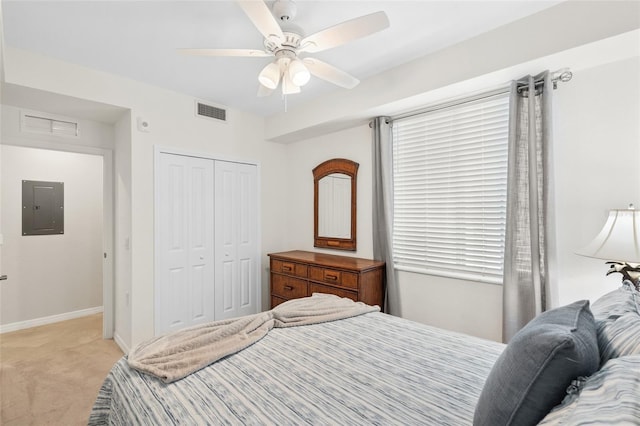 carpeted bedroom featuring electric panel, a closet, and ceiling fan