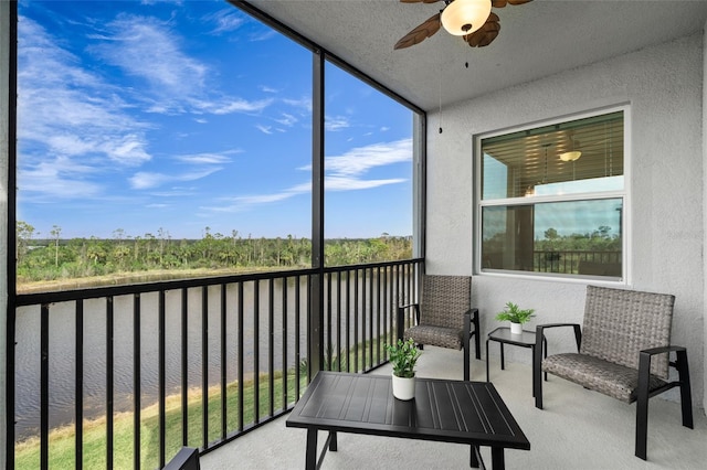 sunroom featuring ceiling fan