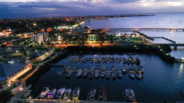 aerial view at dusk featuring a water view