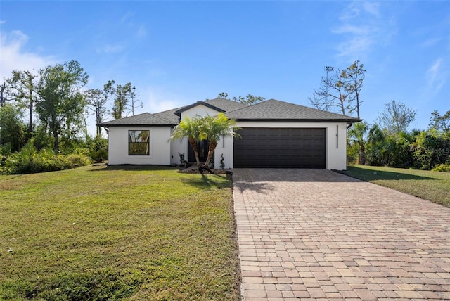 view of front facade with a garage and a front lawn