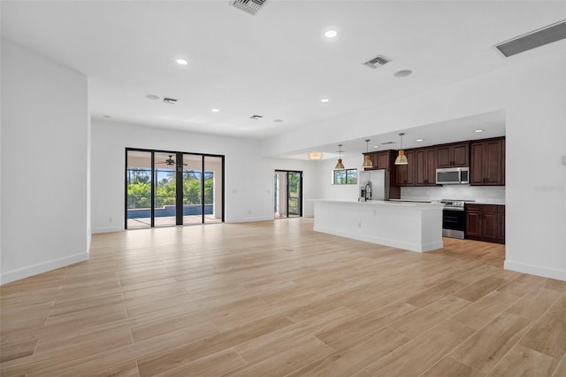 unfurnished living room featuring light hardwood / wood-style flooring and plenty of natural light