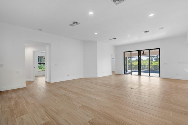 spare room featuring plenty of natural light and light wood-type flooring