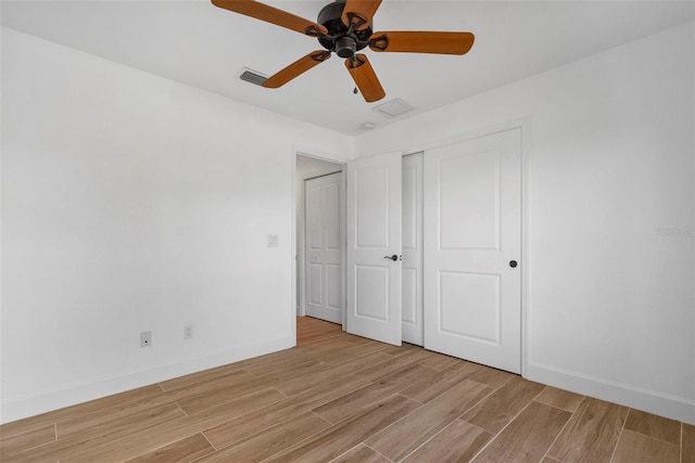 unfurnished bedroom with ceiling fan and a closet