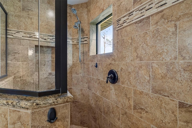 bathroom with tiled shower