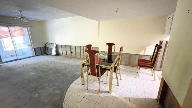 tiled dining space featuring ceiling fan