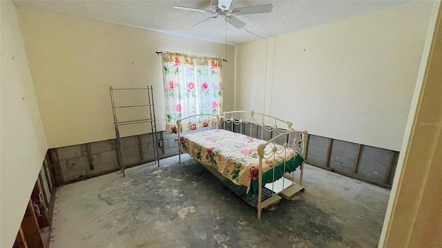 bedroom with ceiling fan and a textured ceiling