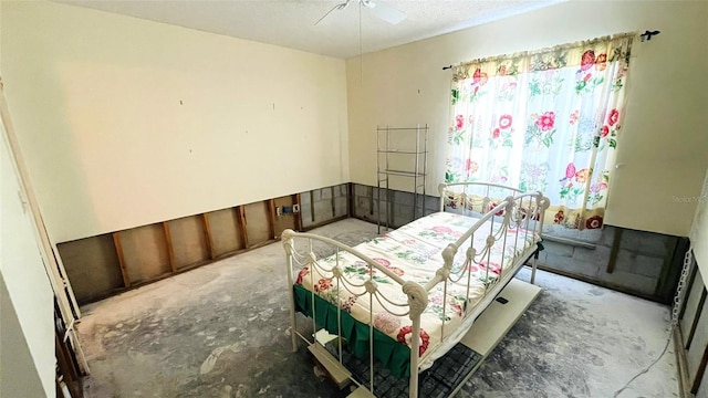 bedroom featuring ceiling fan and concrete floors